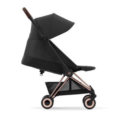 Black stroller with rose gold accents on a white background